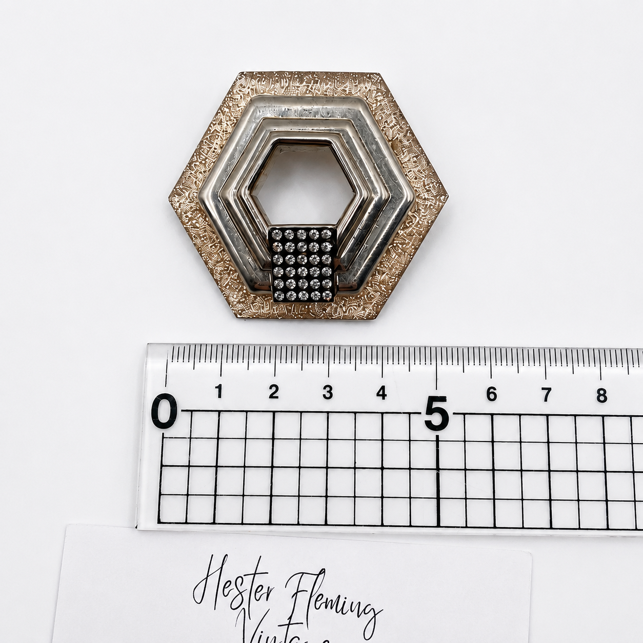 1980s French Pink Lucite Brooch, placed next to a ruler for measurement.