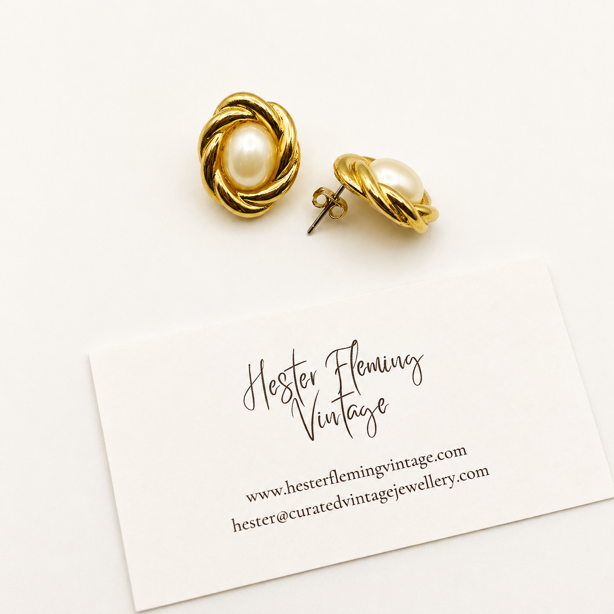 Side view of 1980s gilt knot and pearl earrings for pierced ears.