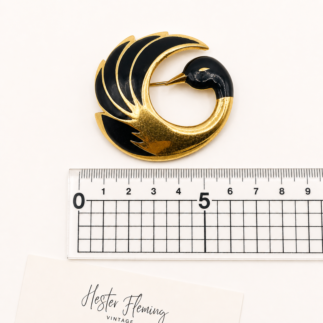 1980s Orena Paris brooch placed next to a ruler for measurement. 