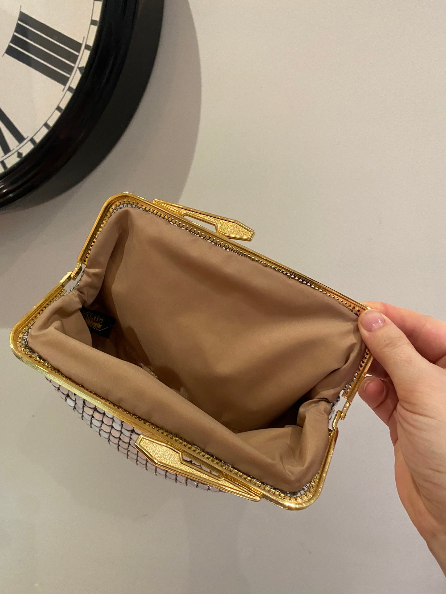 Interior of 1980s Glomesh evening purse with champagne satin lining and gold tone frame