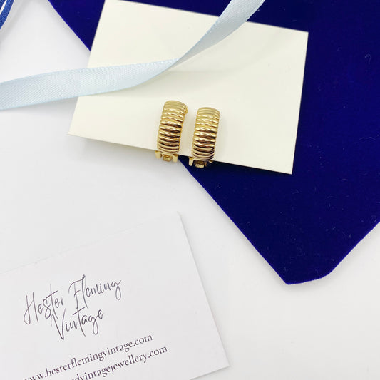 Front view of 1990s vintage Dior gilt clip-on earrings.