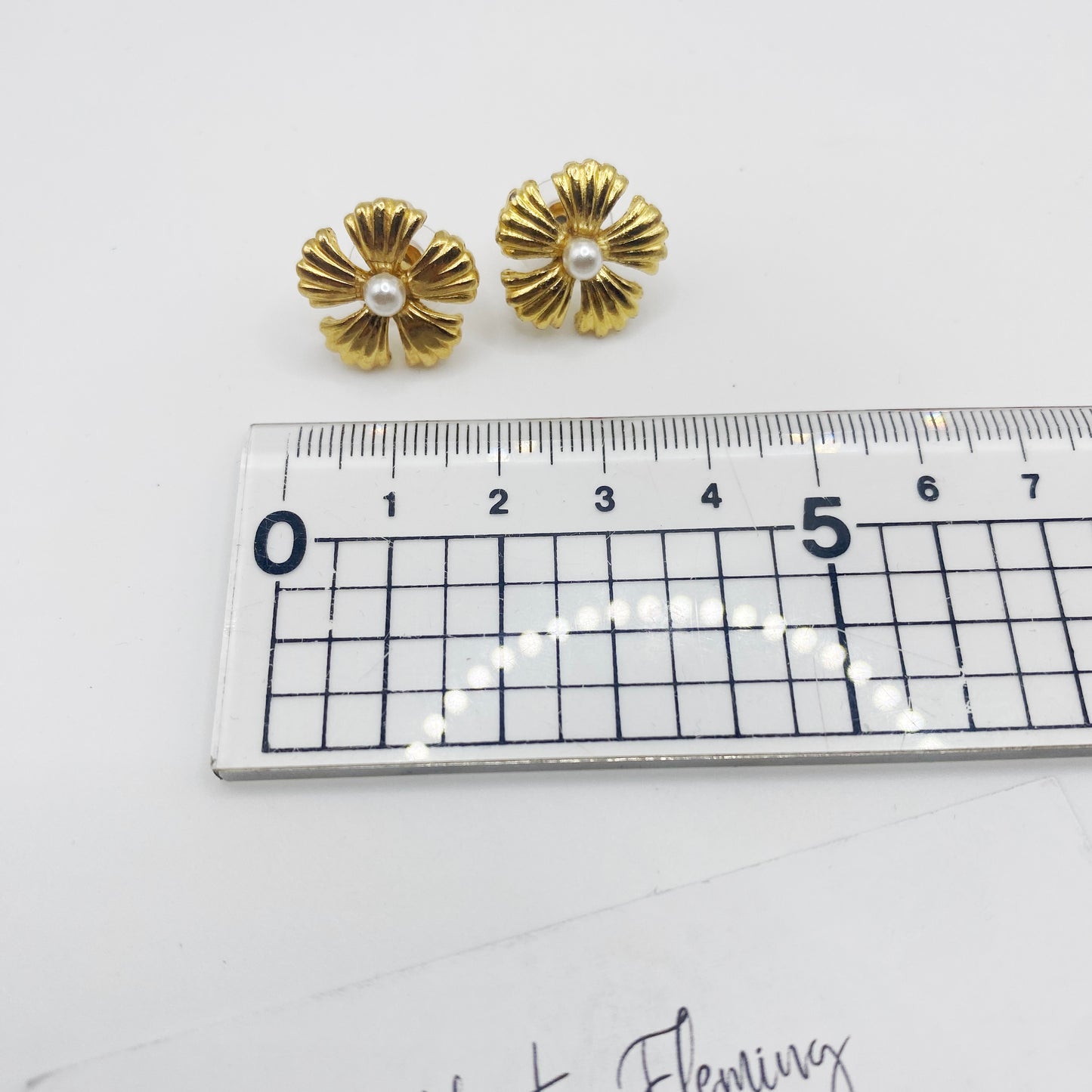 Vintage 90s gold flower earrings shown with ruler for scale