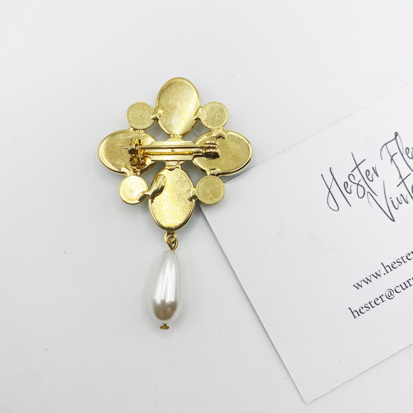 Back of 1990s gold tone Maltese cross brooch showing secure rollover clasp