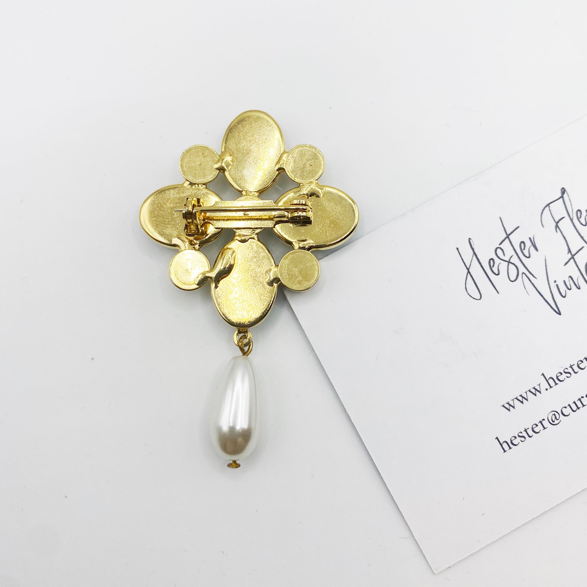 Back of 1990s gold tone Maltese cross brooch showing secure rollover clasp