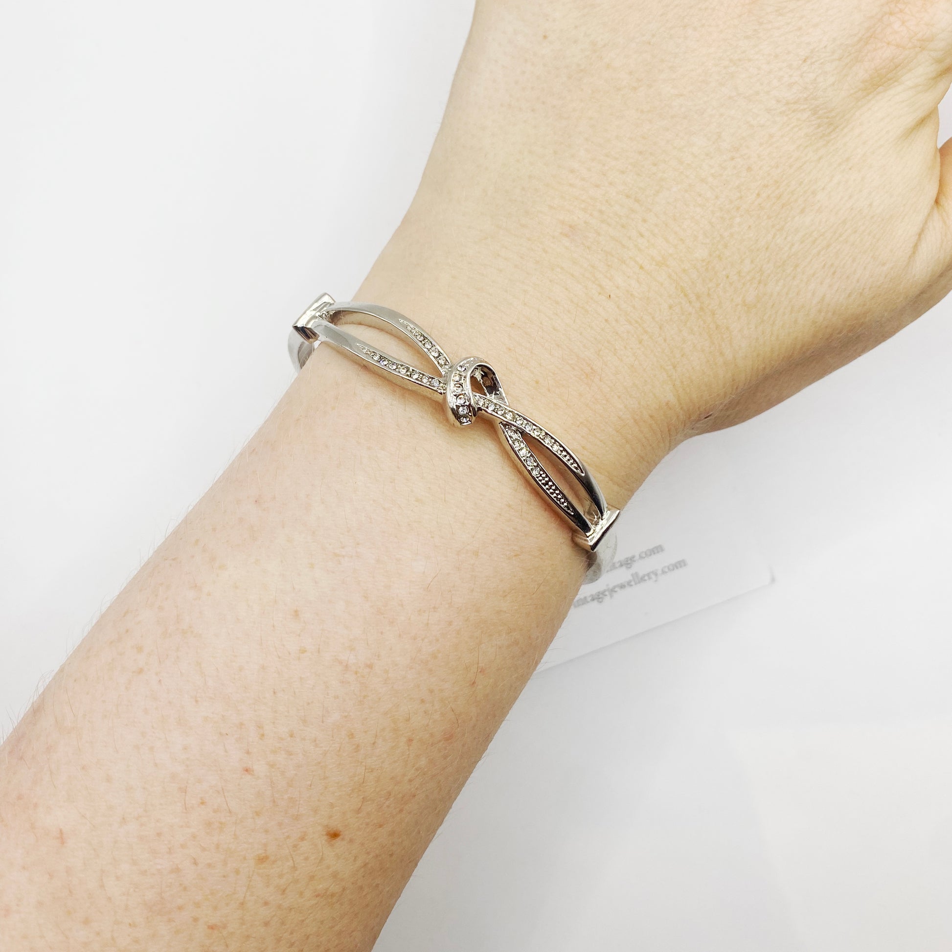 1990s silvertone knot bangle worn on wrist