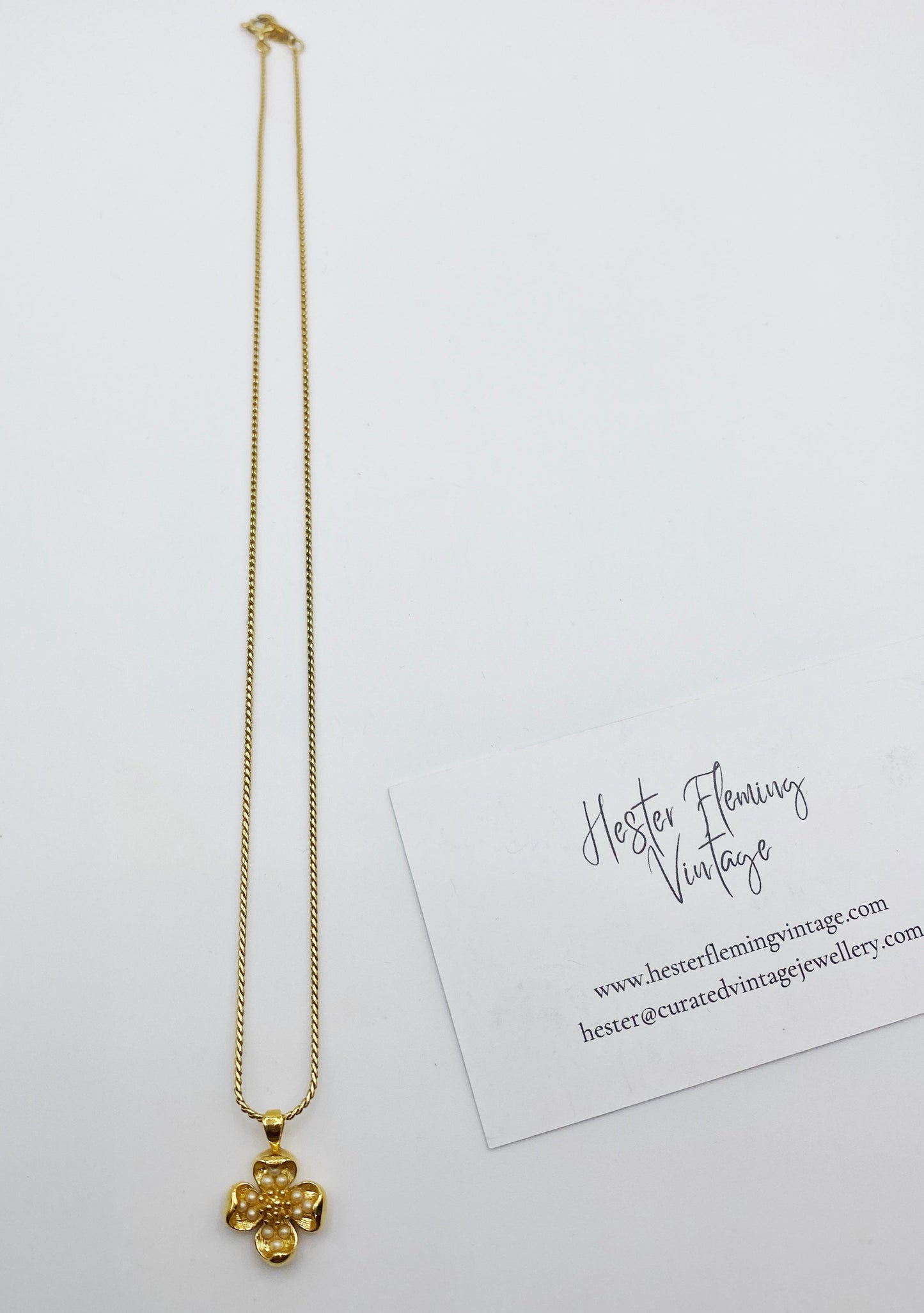 1990s Trifari gold tone dogwood pendant necklace with faux pearl detail