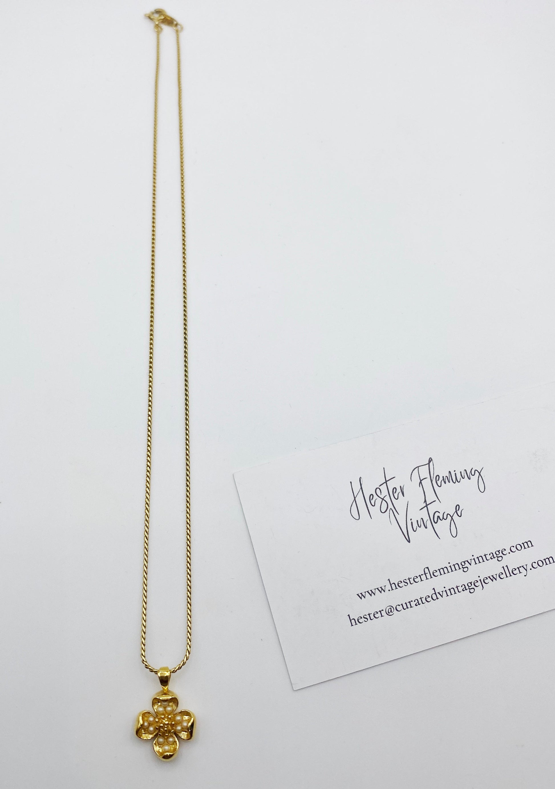 1990s Trifari gold tone dogwood pendant necklace with faux pearl detail