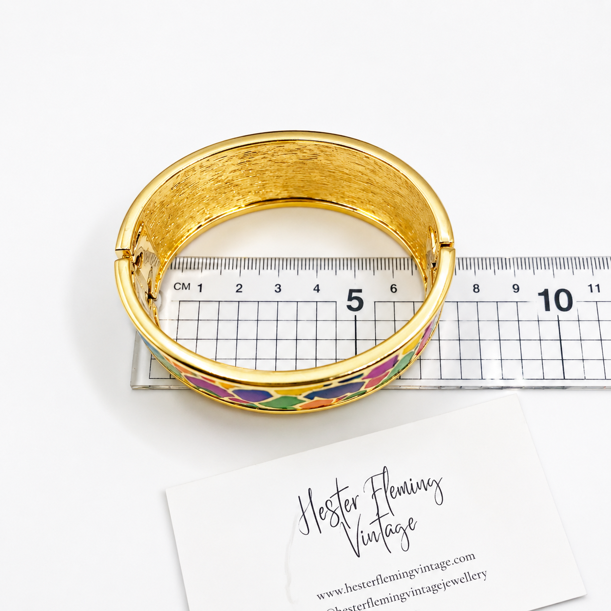 1990s Ewin Pearl Bangle, placed on a ruler for size.  Diameter 6.75cm. 