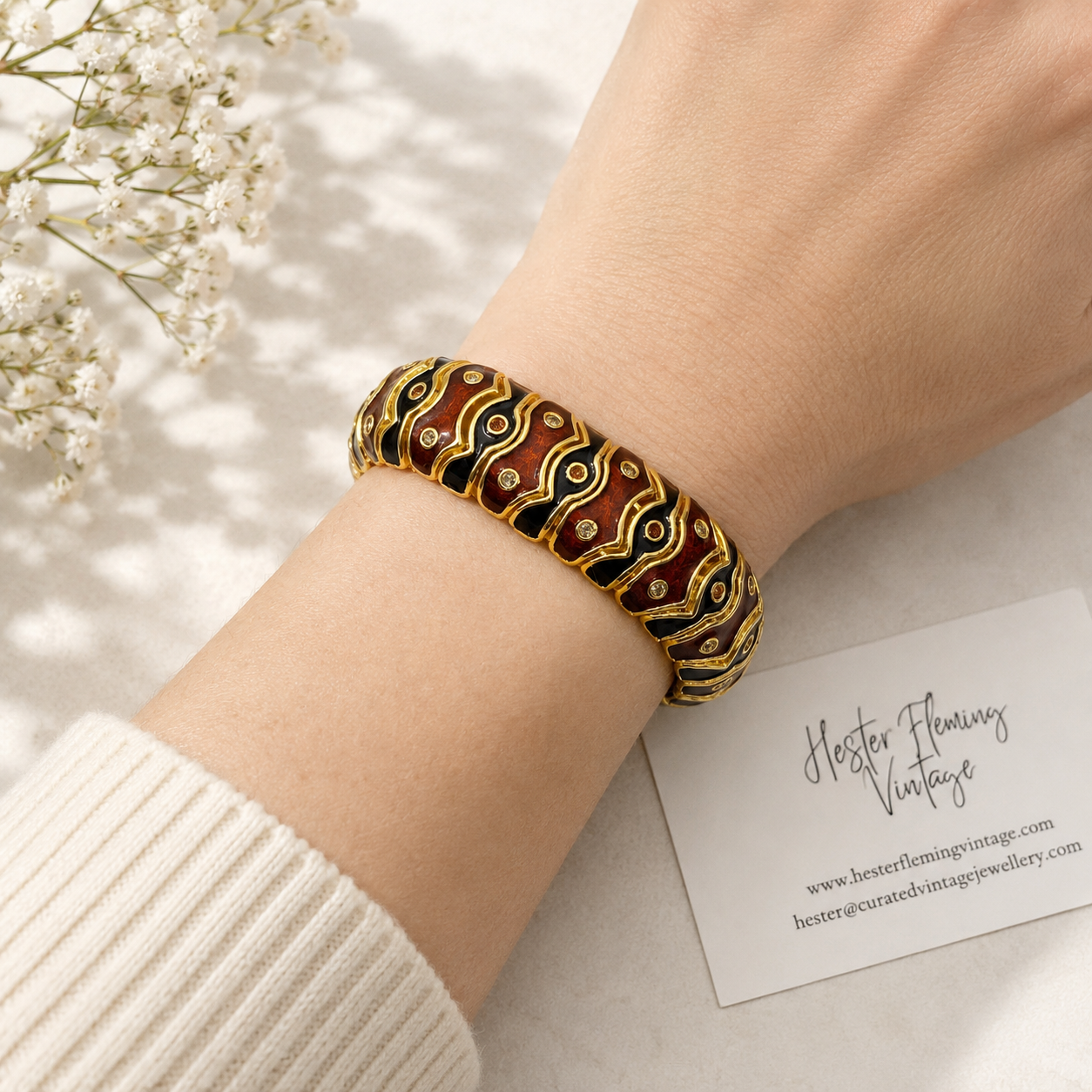 A styled shot of the 1990s Joan Rivers Bracelet. Paired with a cream knit. 