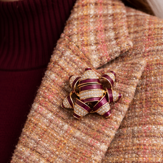 1990s Napier enamel and crystal brooch styled on a blazer.
