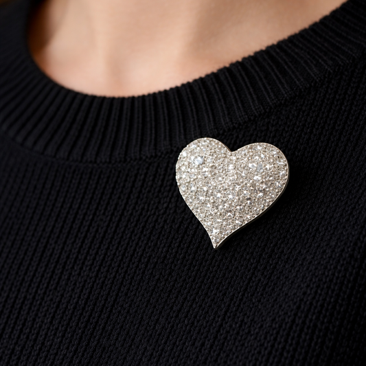 1990 Swarovski crystal heart brooch, styled on a model wearing a black knit. 