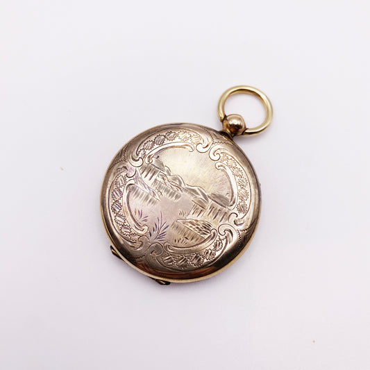 Circa, 1900s. An etched Victorian locket with original photos. Good vintage condition.