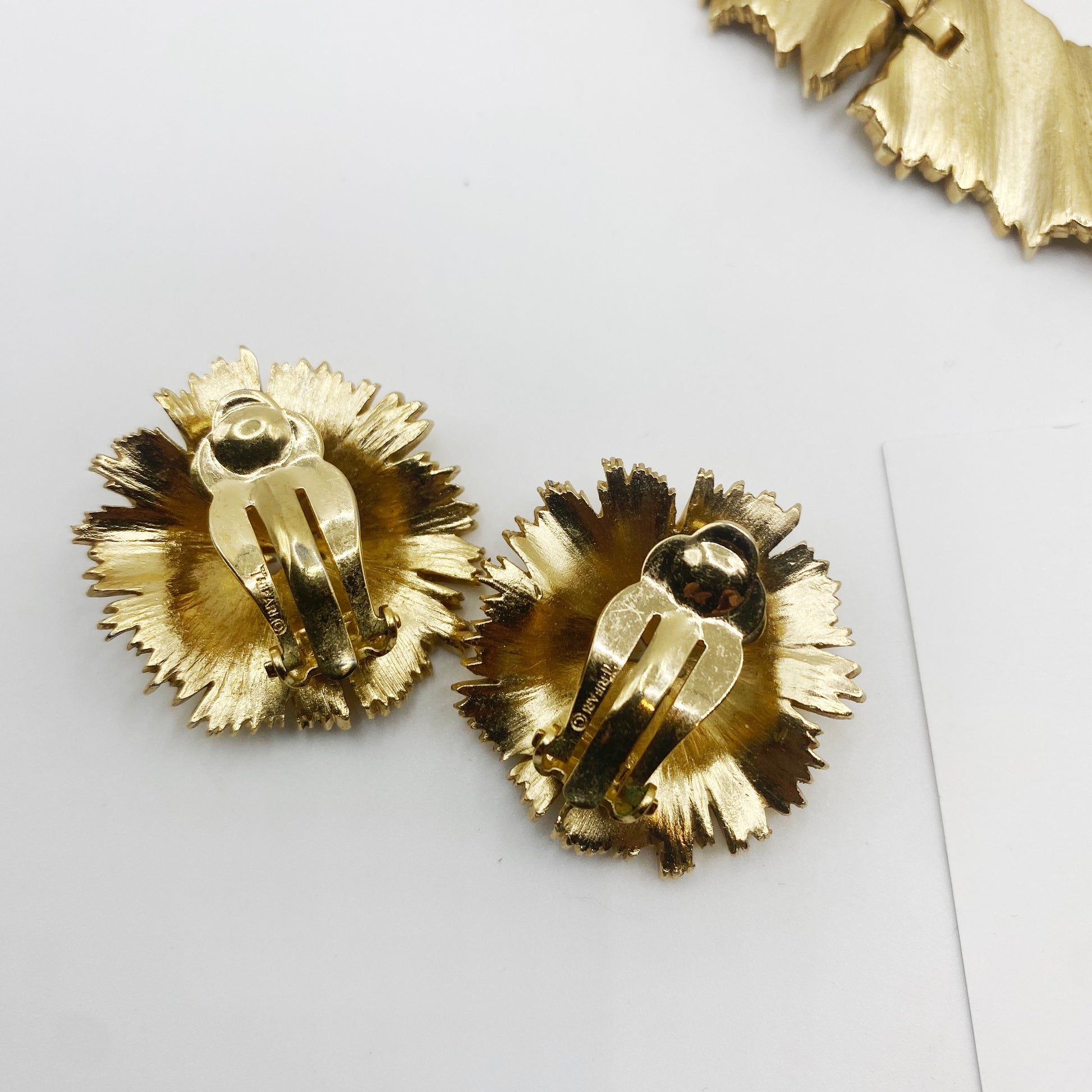 Pair of 1960s Trifari gold-tone clip-on earrings, back view.
