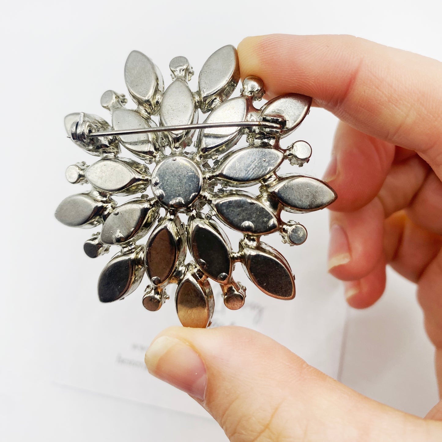 Back view of 1950s Crystal brooch, set in silvertone.
