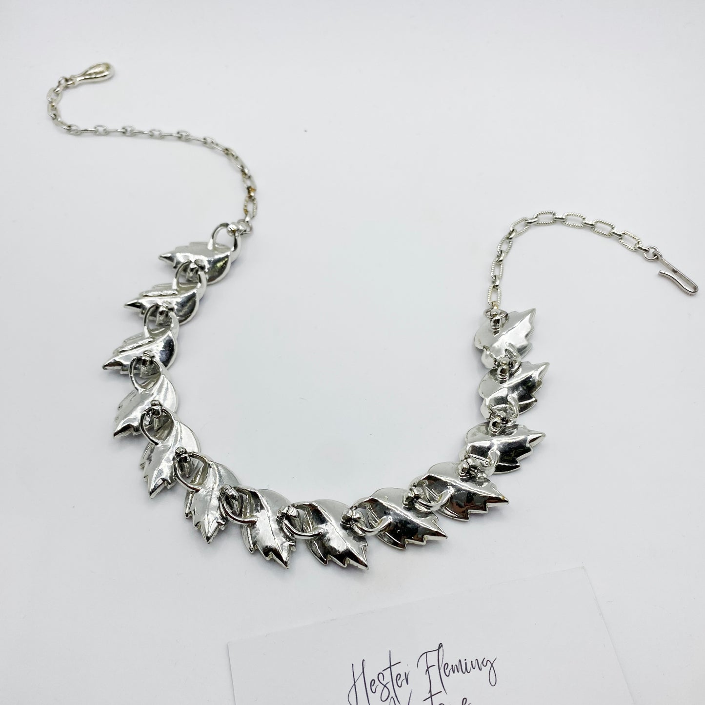 Back view of the 1950s Coro enamel leaf necklace. Set in silvertone. Good condition.