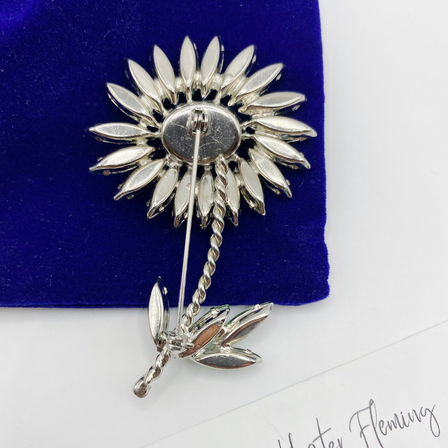 Back view of the 1960s Floral rhinestone brooch. Set in silvertone. Good condition, minor signs of age evident. 