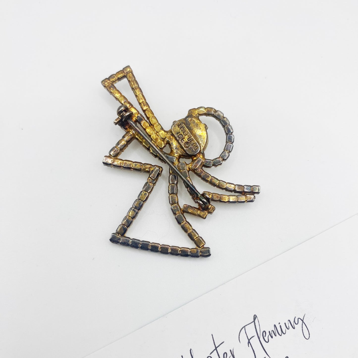 Back view of Eisenberg Ice Christmas Angel Brooch, goldtone setting.