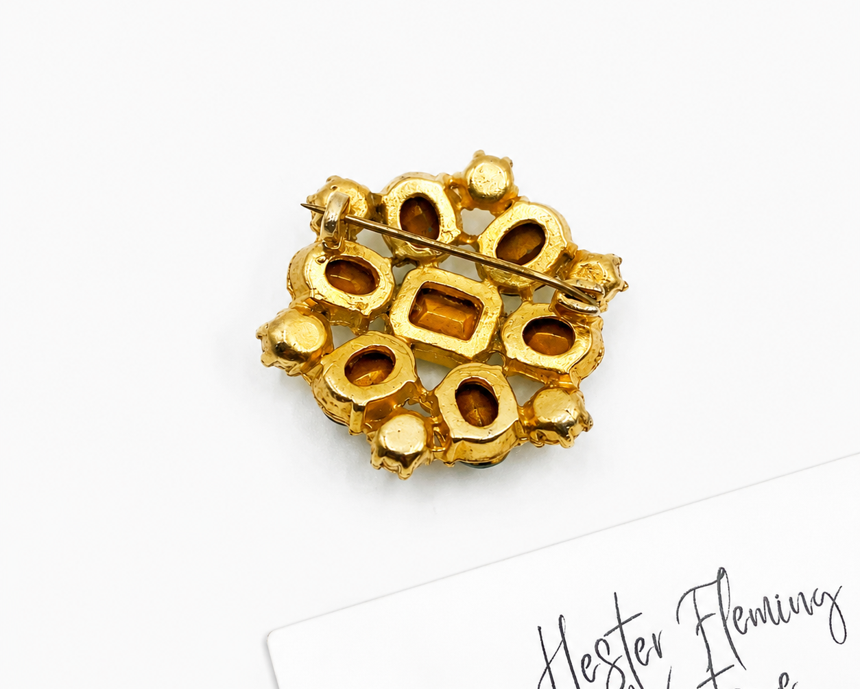 High quality gold plating, mid century emerald crystal brooch. Secure roll over clasp. 