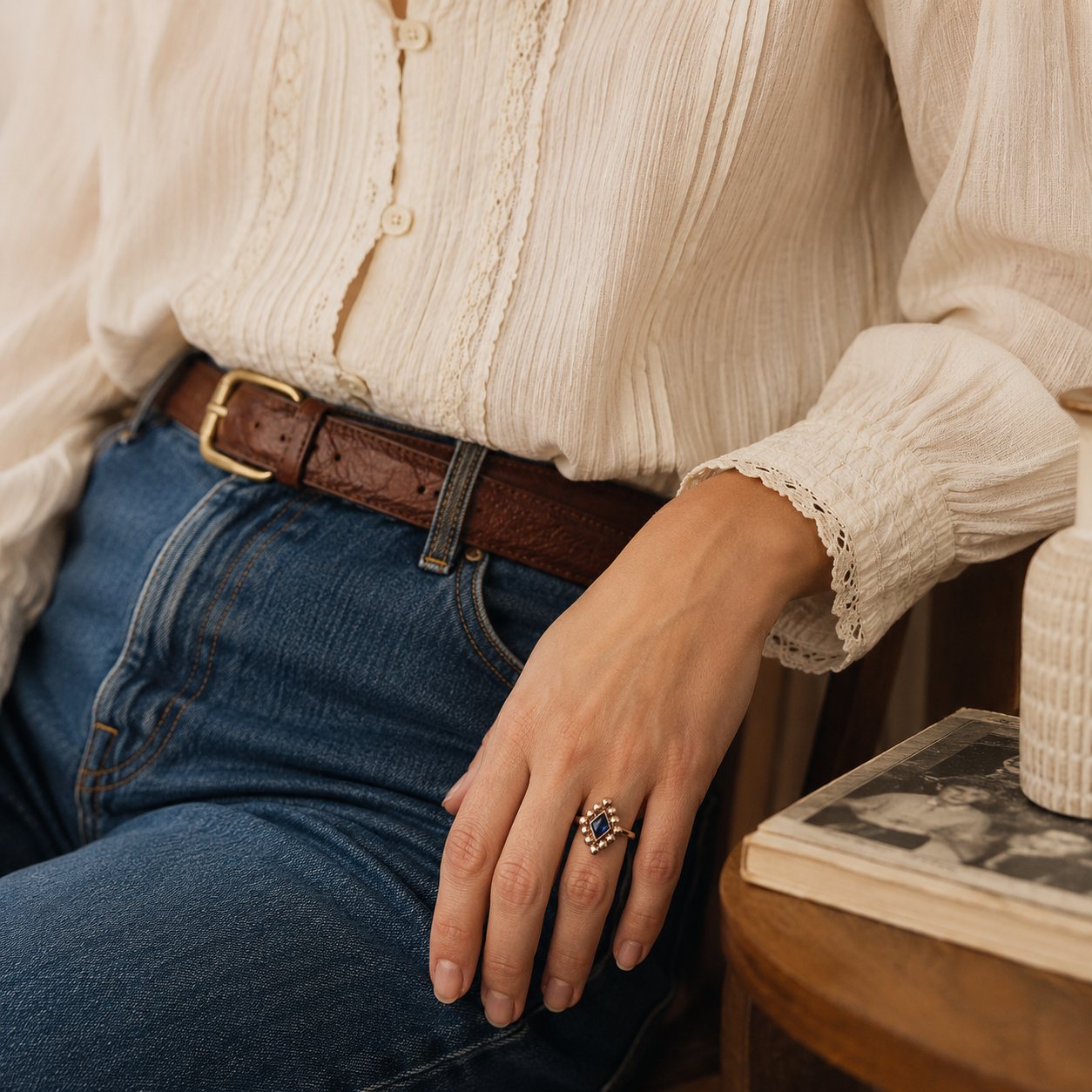 Boujou Munidor Sapphire Crystal Ring, styled on a model, wearing jeans and renaissance style shirt. 