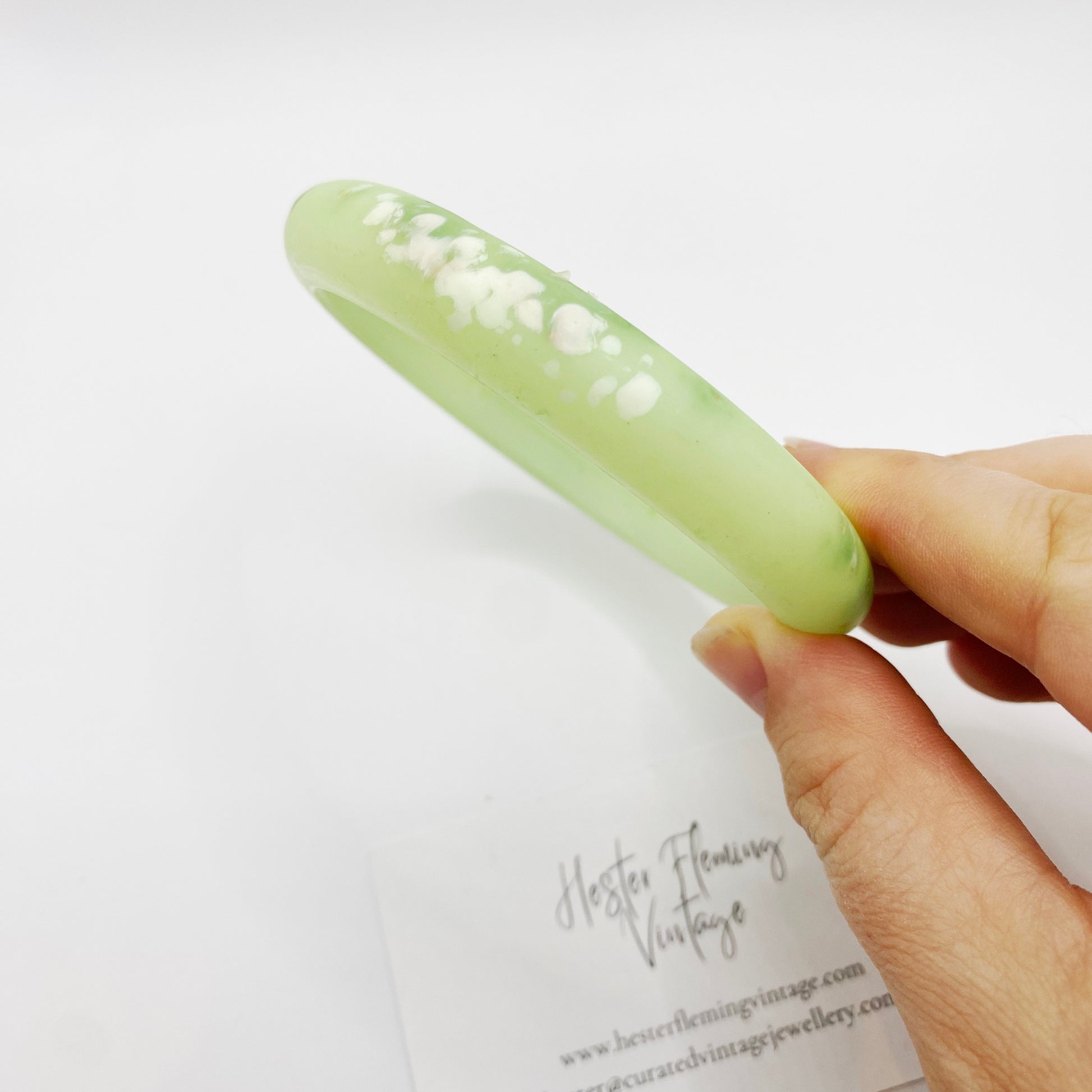 Close of vintage 80s green polymer bangle. White marbling detail.