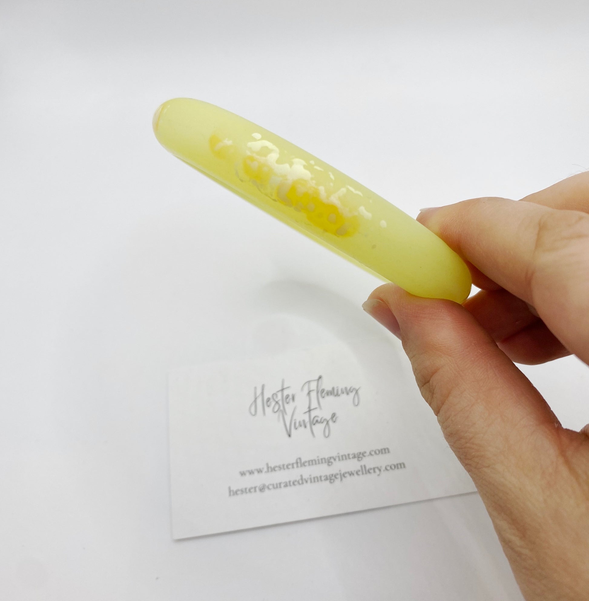 Close up of Vintage Yellow Polymer Bangle, white marbling detail.