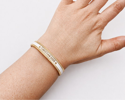 White enamel, Dior bangle shown on wrist. 