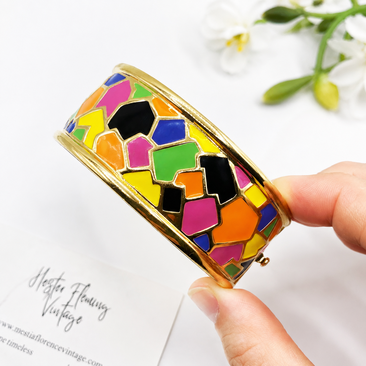 Vintage 1990s Erwin Pearl Harlequin Design Bangle, held by hand. 