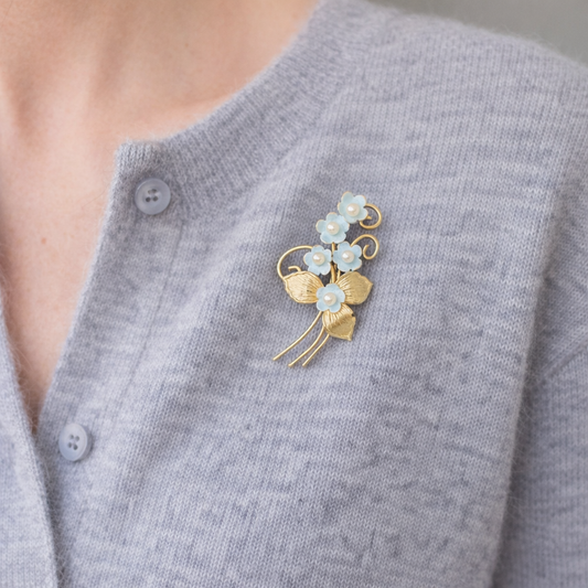 1940s 12kt Forget-me-not brooch styled on a grey cashmere cardigan 