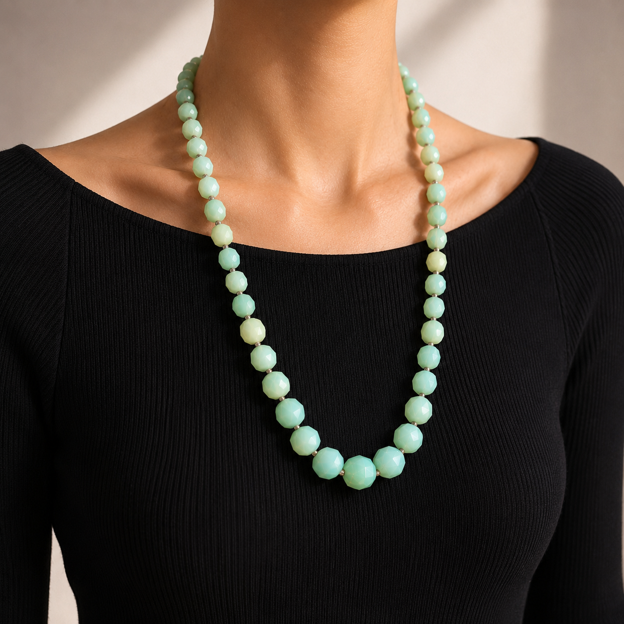 French deco milk glass beads, styled on a contemporary model wearing a black top. 
