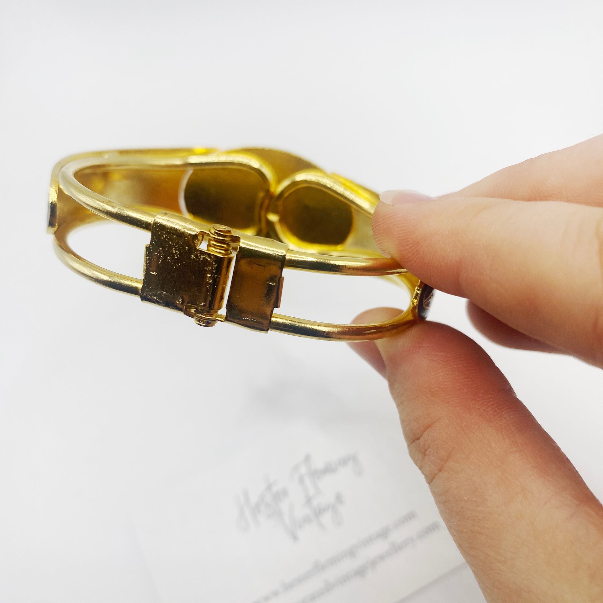 Close up of hinge on 80s retro cloisonne bangle.