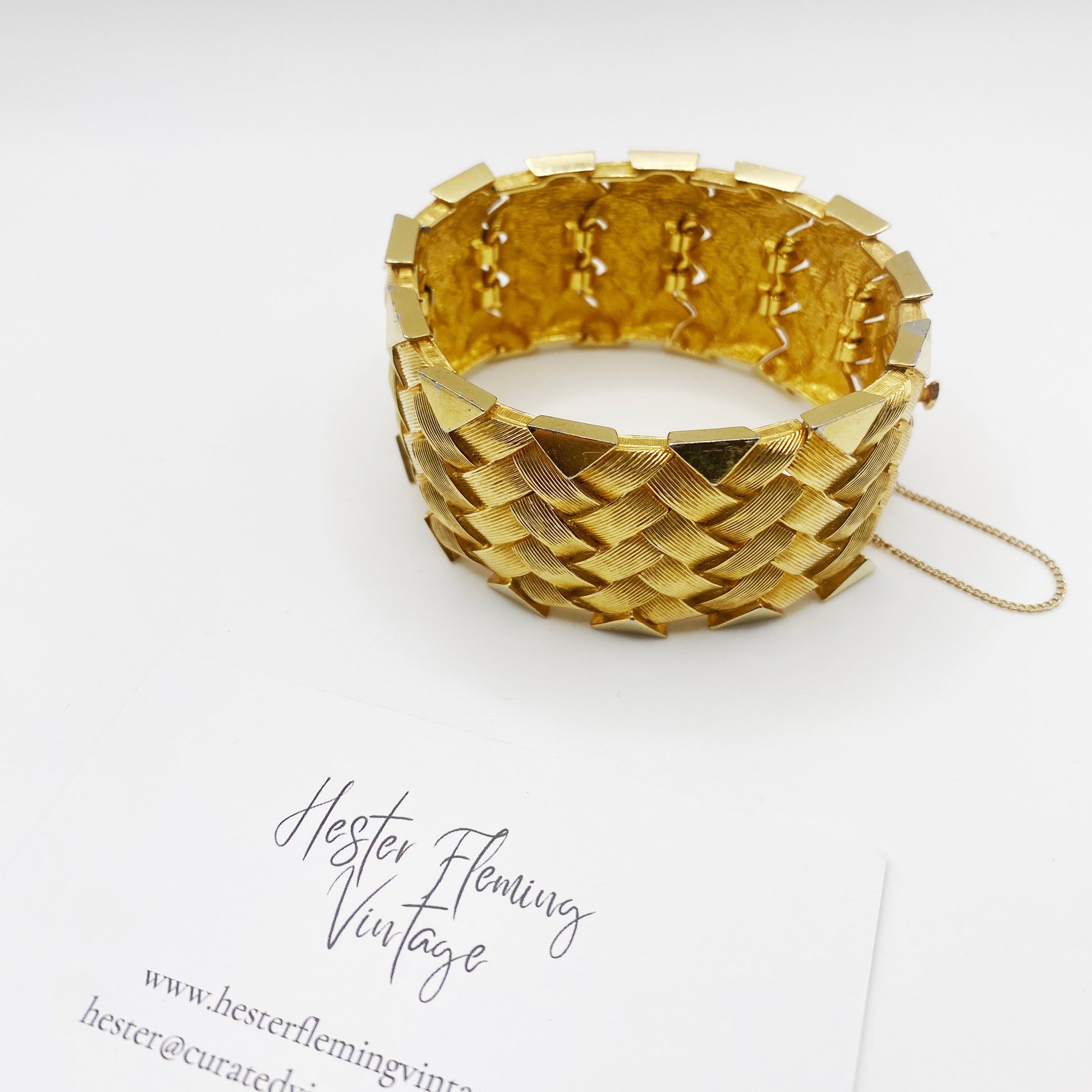 Side angle of mid-century Boucher cuff bracelet showing textured gold finish