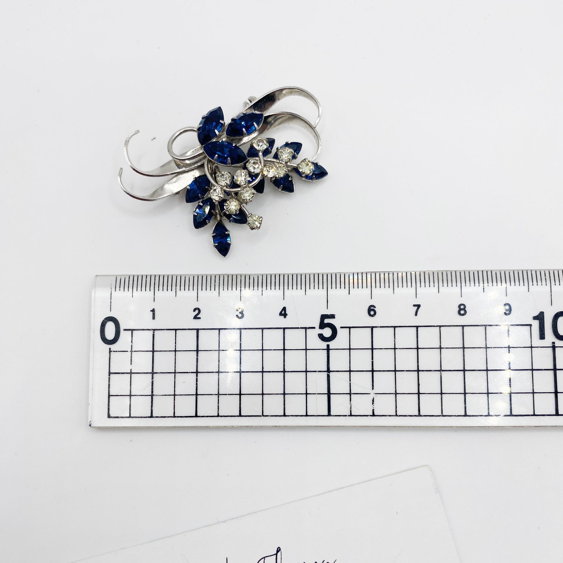1940s Jewelcrest brooch placed next to ruler for scale.