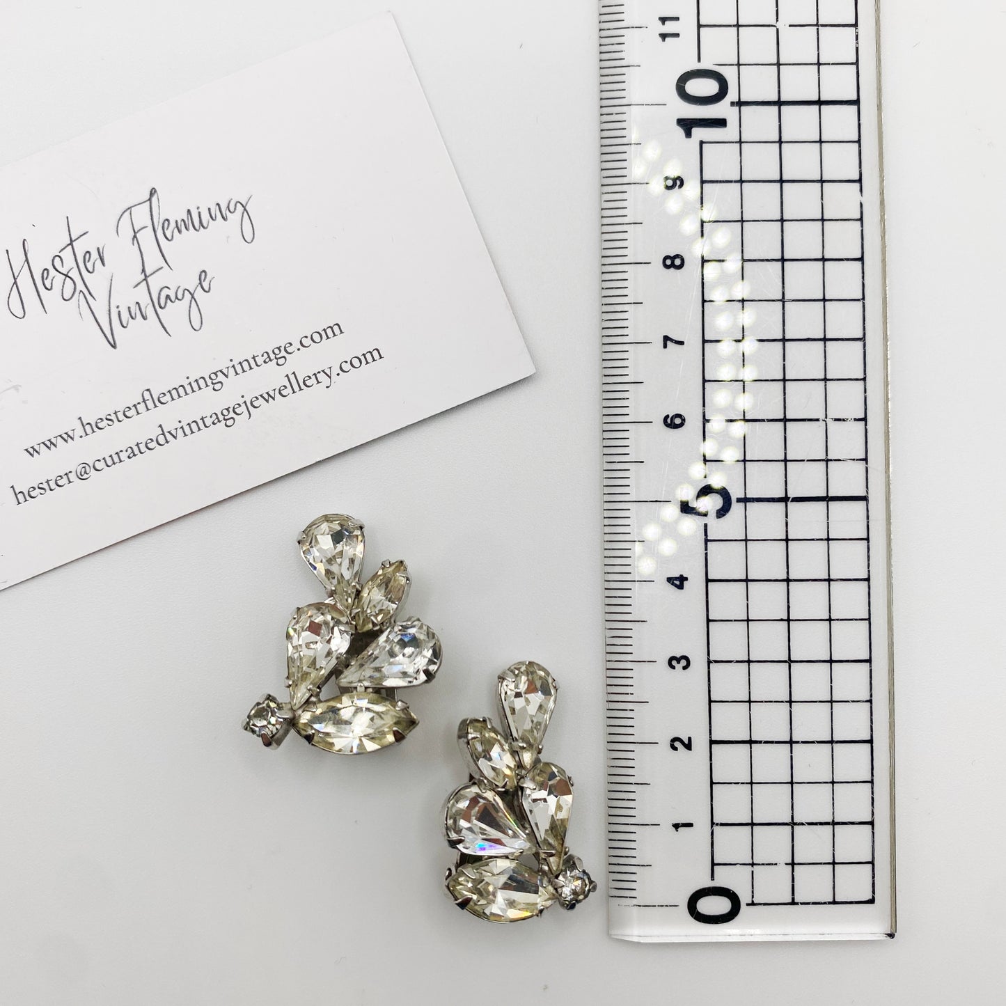 Vintage mid century weiss earrings, placed next to ruler for scale. 