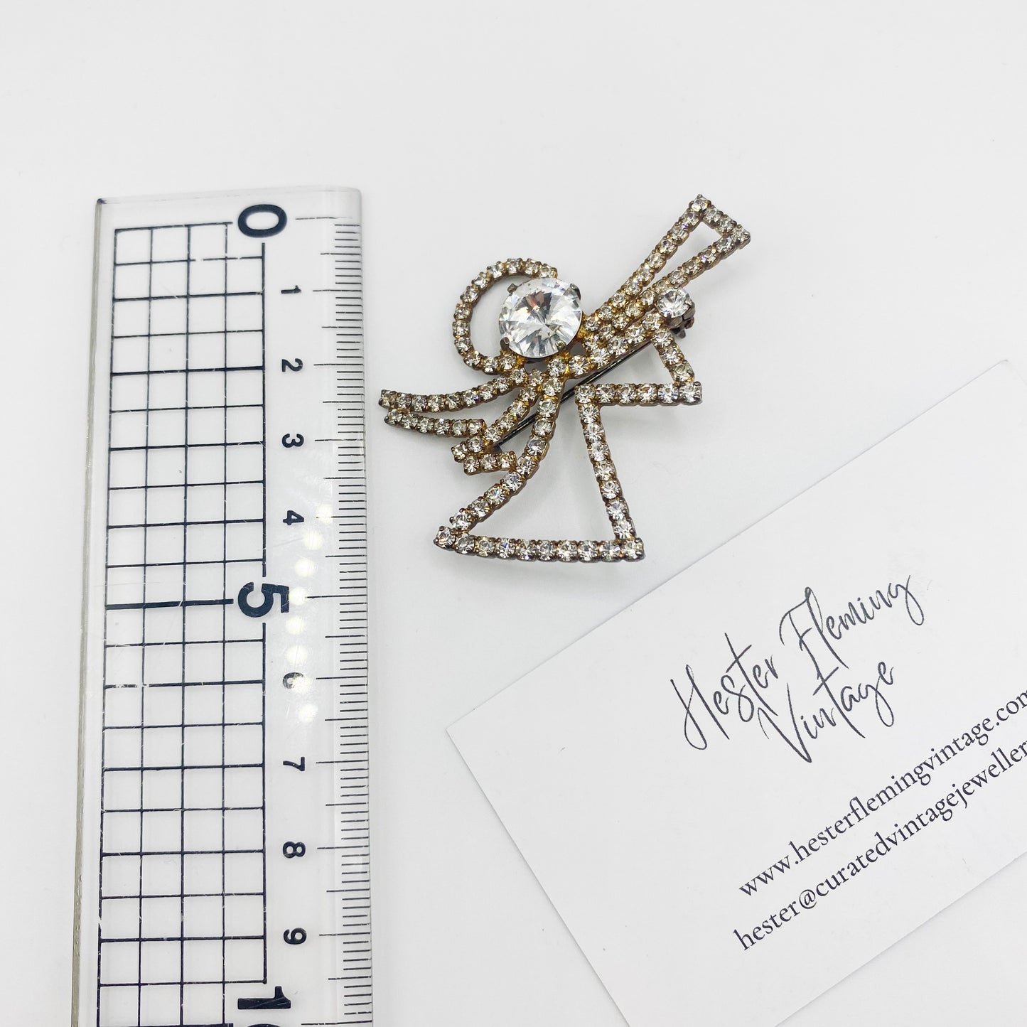5cm x 5cm measurement of sparkling Swarovski crystal angel brooch.