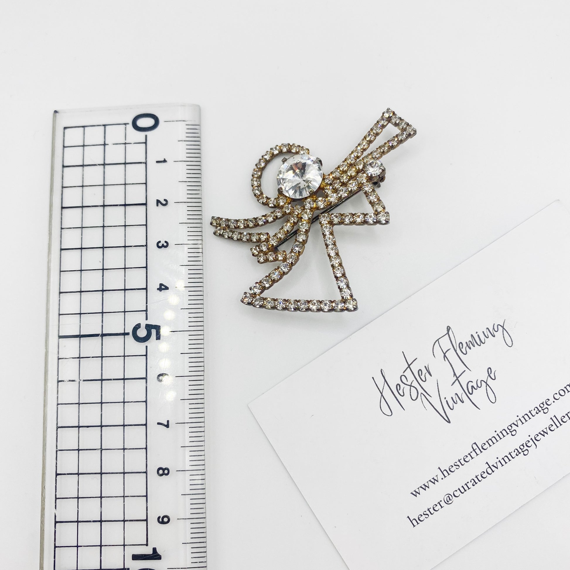5cm x 5cm measurement of sparkling Swarovski crystal angel brooch.