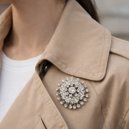 Mid-Century crystal brooch, styled on a model wearing a trench coat.