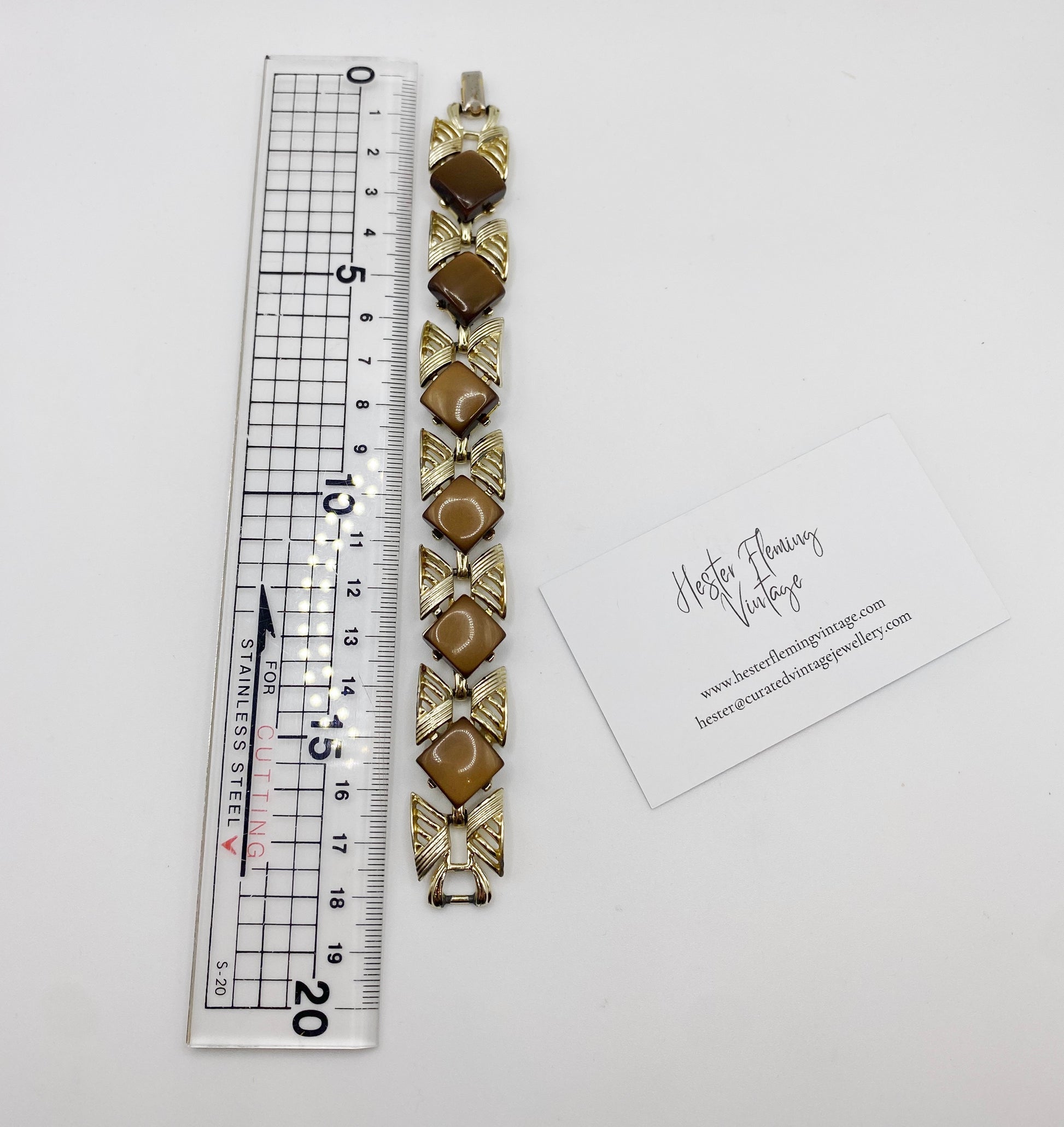 Vintage Coro Bracelet on white background next to ruler.