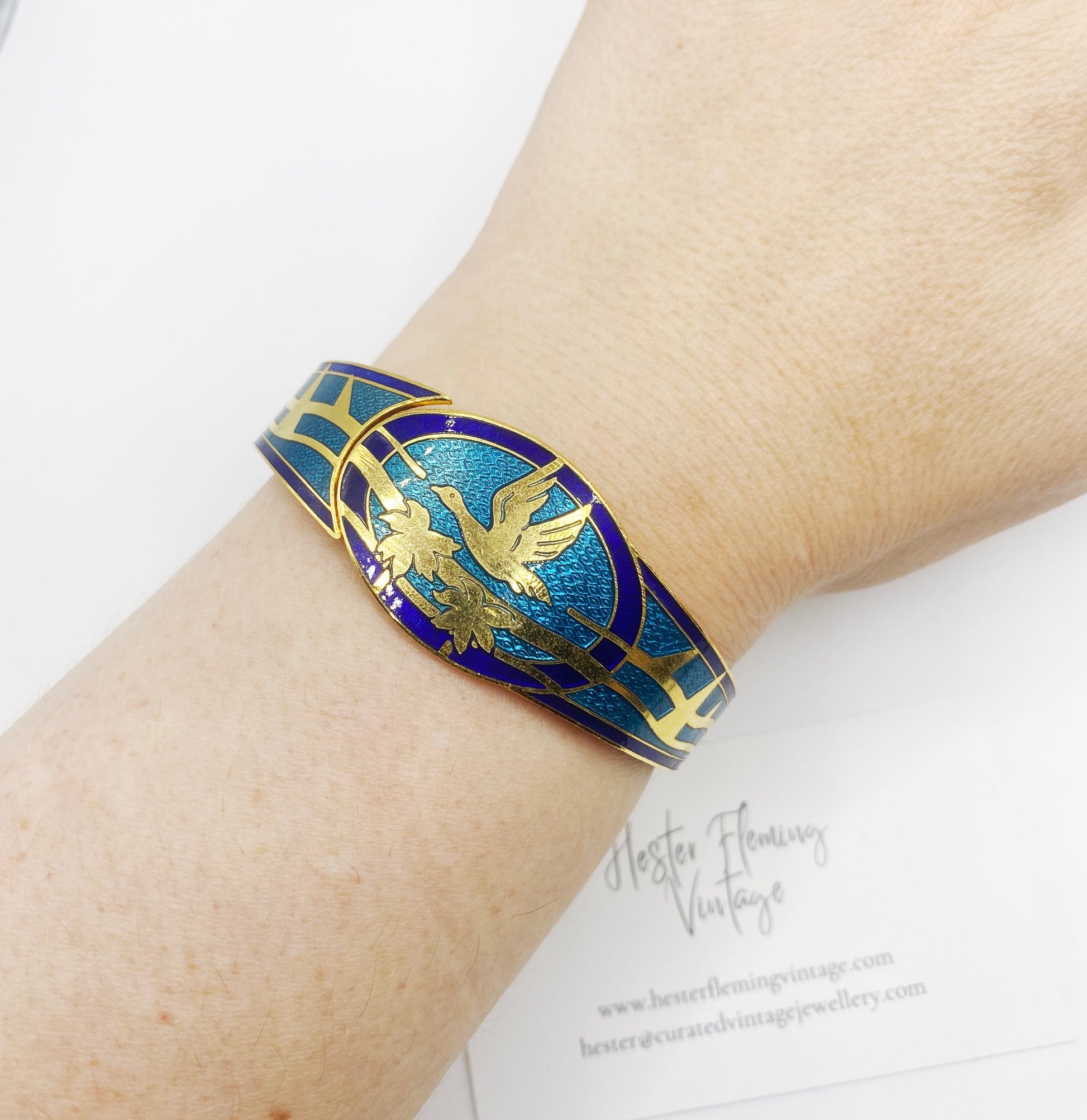 Retro 80s Enamel Cloisonne Bangle, with Swan flying over palm trees. Shown on wrist.