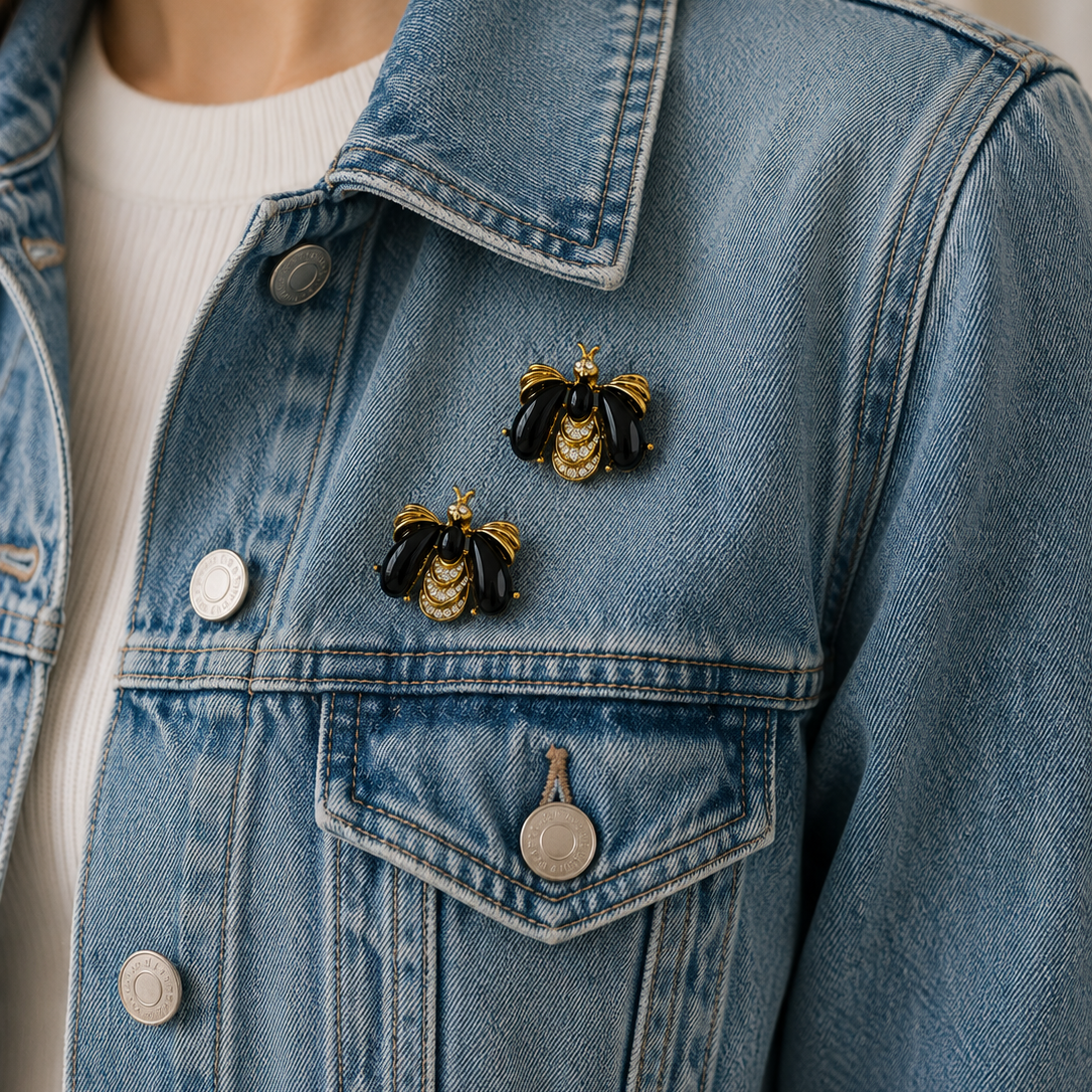 Style shot of the 1990s Givenchy Bee brooch set, on denim. 