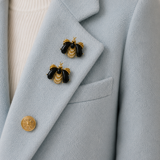 Vintage 1990s Givenchy Bee Brooch Set styled on a light blue cashmere jacket.
