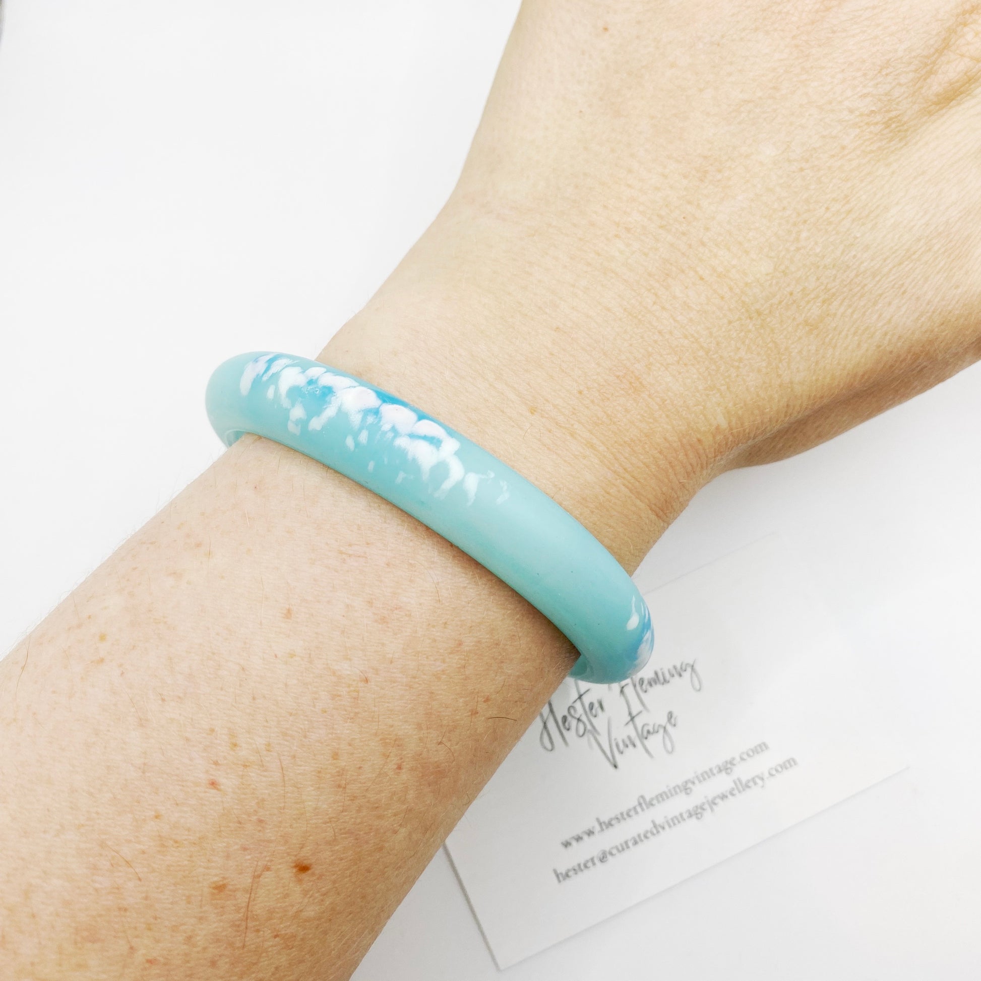 Vintage 80s blue polymer bangle on wrist.