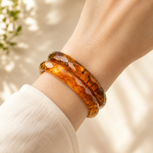 Style shot of the vintage 1930s-40s, apple juice bakelite bangles, styled with a relaxed cotton shirt.