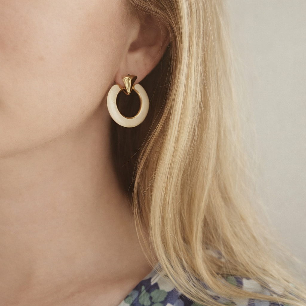 Vintage 1970s Cream Enamel Earrings, styled on a model. 