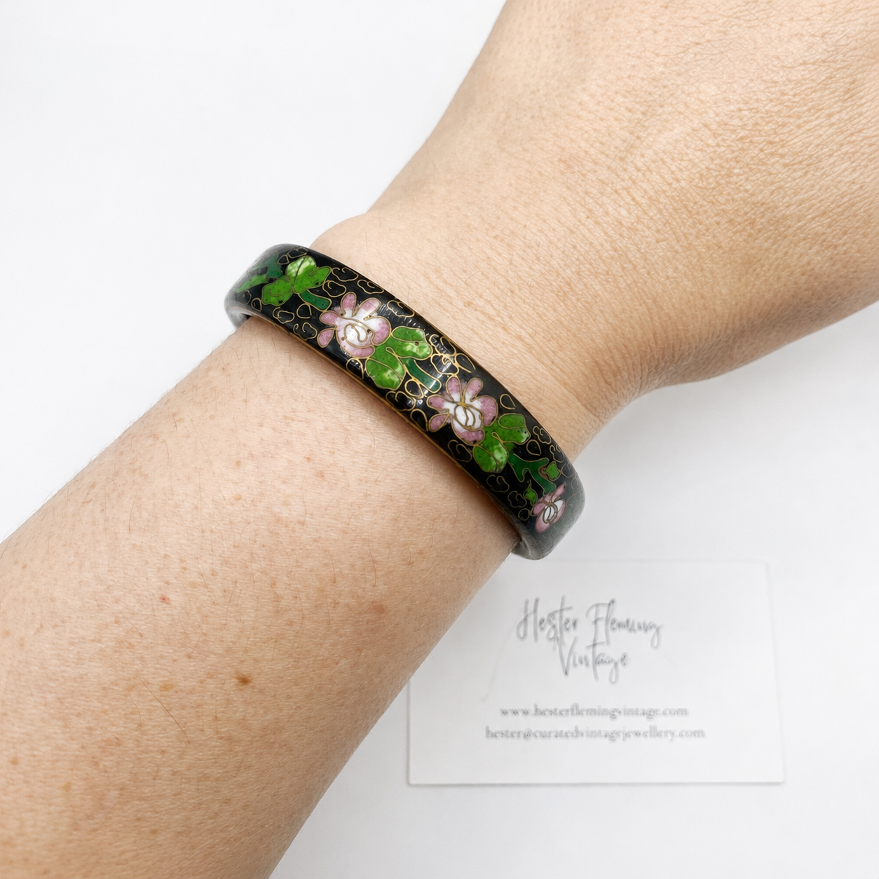 Bracelet with floral design worn on wrist against a white background