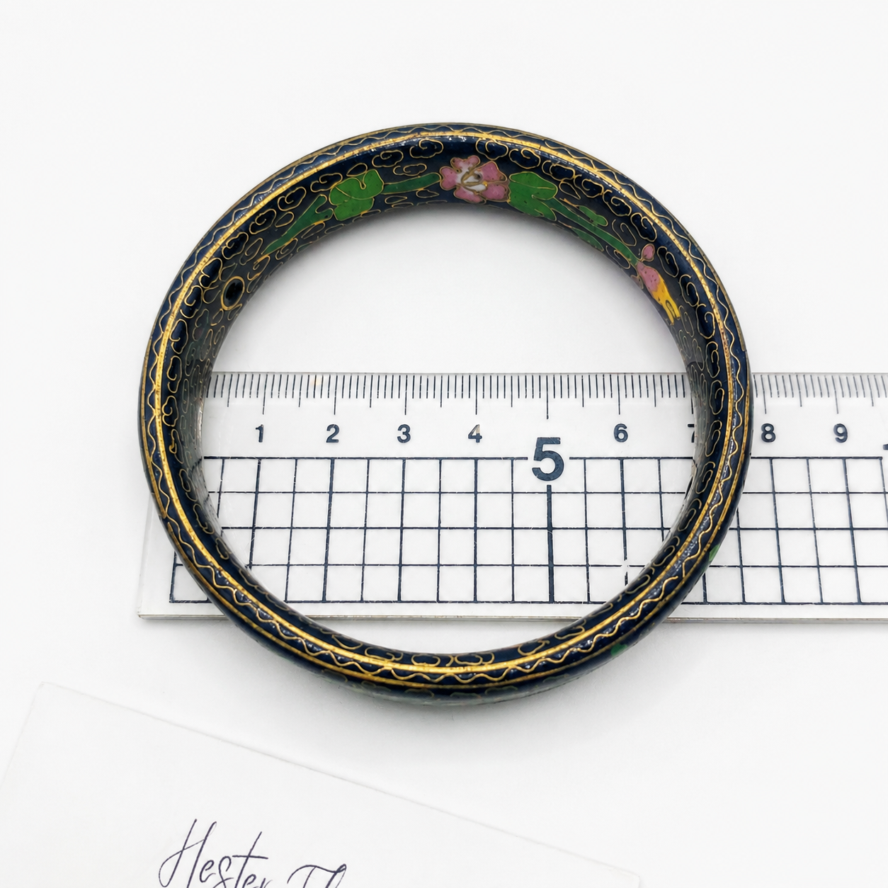 1970s Cloisonne' Bangle placed on a ruler for measurement. 