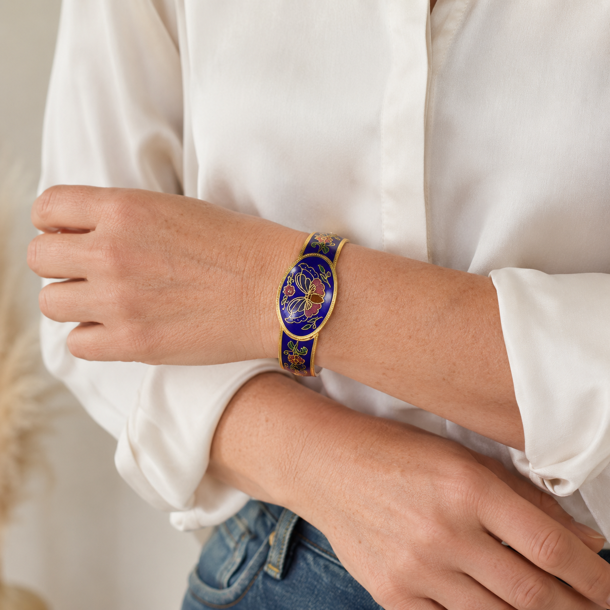 Vintage 1980s Cloisonne' bangle styled on a model wearing a white shirt and denim jeans. 