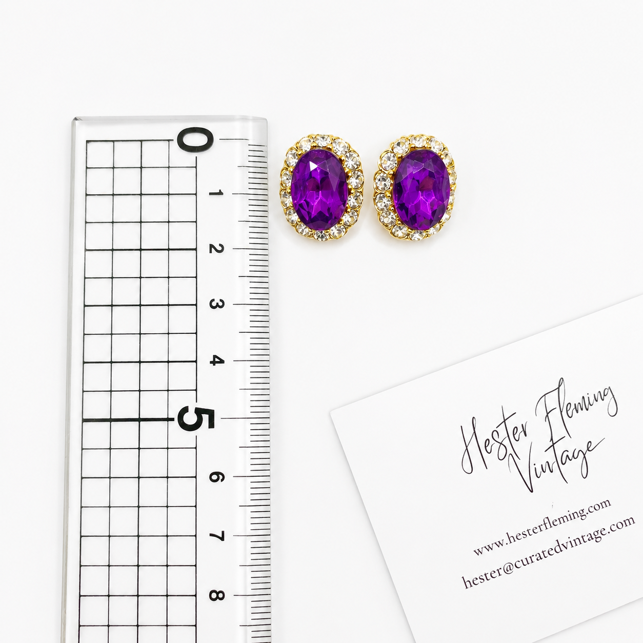 Vintage 1980s Crystal Earrings, placed next to a ruler size. 