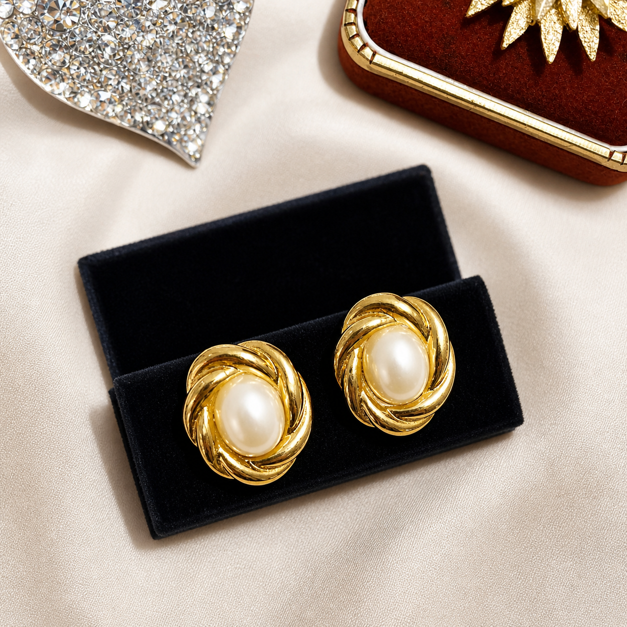 Close up of vintage 1980s gilt knot pearl earrings, for pierced ears.