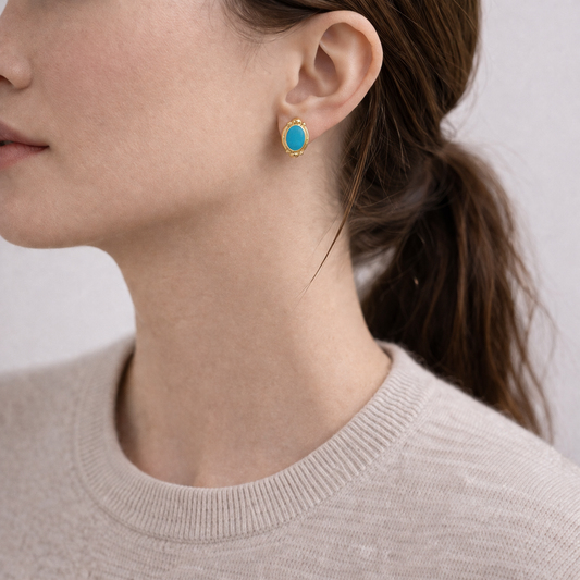 1990s Turquoise and gilt earrings for pierced ears, styled on model. 