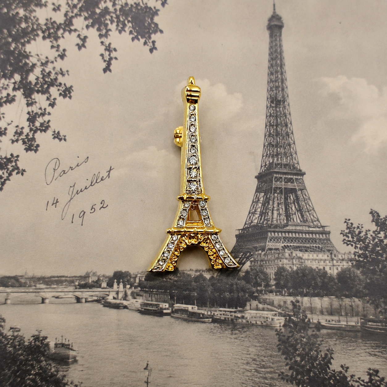 Vintage 1990s Eiffel Tower Souvenir Brooch, with a 1950s black and white photo as the backdrop. 